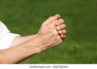 Man Praying Outdoors On Sunny Day, Closeup