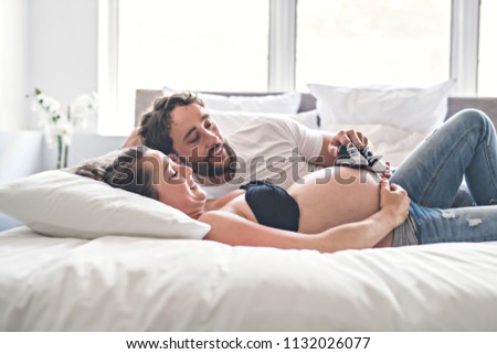 Similar – Image, Stock Photo Man and pregnant woman looking baby clothes