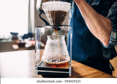 Man prepares coffee in style "pour over"  in barista school. - Shutterstock ID 593419151