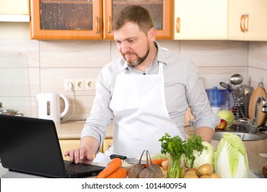 A Man Prepares Food On A Prescription From The Internet. Adult 40 Year Old Man Leads A Culinary On-line Blog About Healthy Eating.