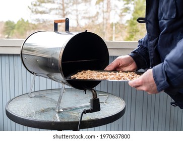 A Man Prepares Food, Wood Shavings For An Electric Smokehouse.