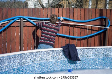 A Man Preparing Above Ground Swiming Pool To Summer, Sunny Day Shot