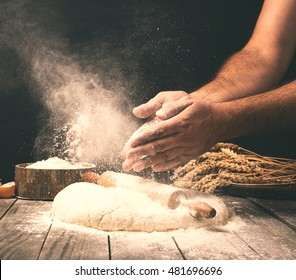 Man preparing bread dough on wooden table in a bakery close up - Shutterstock ID 481696696