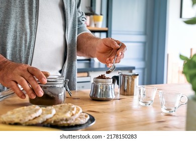 Man Preparing Classic Italian Coffee In The Mocha In The Kitchen, Filling Funnel Of A Moka Pot With Ground Coffee. Coffee Brake. Morning Habit.