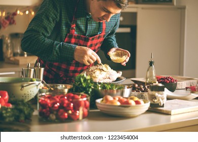 Man preparing delicious and healthy food in the home kitchen for christmas (Christmas Duck or Goose) - Powered by Shutterstock