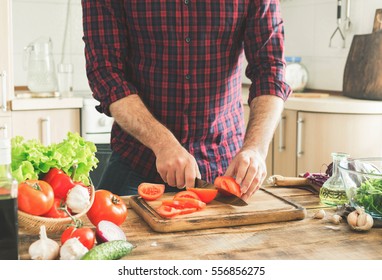 Man preparing delicious and healthy food in the home kitchen on a sunny day - Powered by Shutterstock