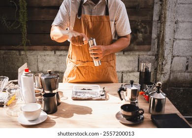 Man is preparing a fresh brew by Grinding roasted Arabica beans into a manual stainless steel grinder at a rustic outdoor café setup, delicious and aromatic coffee experience - Powered by Shutterstock