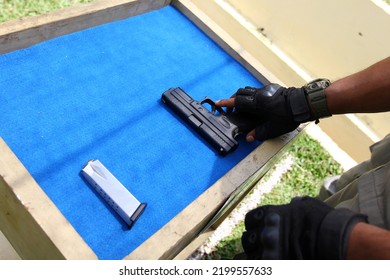 A Man To Preparing Gun At Training Shooter School. 9mm Automatic Pistol Gun Holding In Hand Of Gun Shooter, Training By Using Pistol Gun To Save And To Protect