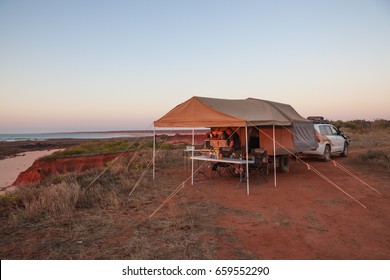 Man Preparing A Meal Under Awning Of Off Road Camper Trailer At Sunset At James Price Point, Kimberley Australia