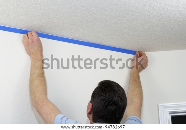 Man Preparing Paint Ceiling By Masking People Objects