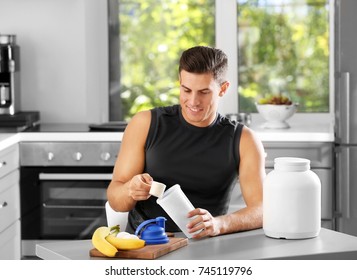 Man Preparing Protein Shake In Kitchen