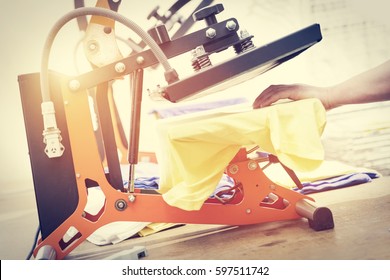 Man Preparing T-shirt For Printing In The Silk Screen Printing Machine