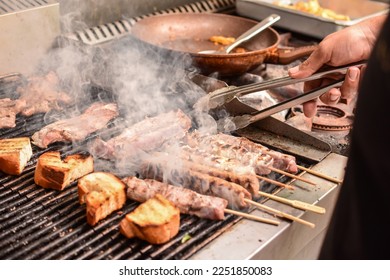 Man prepering greek meal in grill 