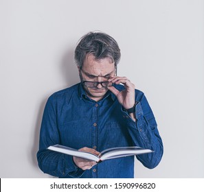 Man With Presbyopia Reading A Book