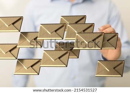 A man presenting 3D rendered golden letters, email sign