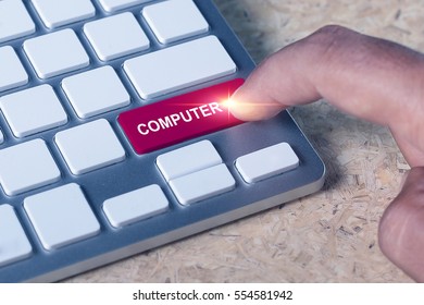 Man pressed keyboard button with computer word