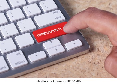 Man pressed keyboard button with cybersecurity word
