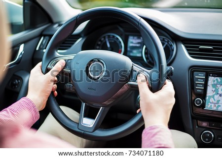 Man presses the buttons on the multifunction steering wheel