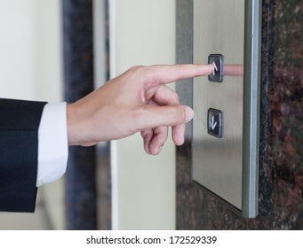 Man Pressing Elevator Button