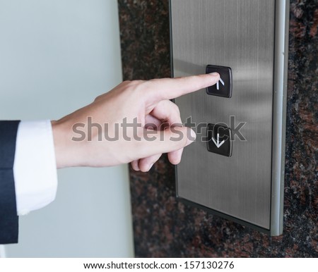 Man pressing elevator button