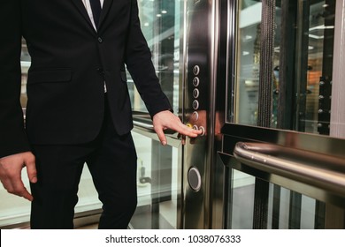 Man pressing elevator button. finger presses elevator button. businessman in lift