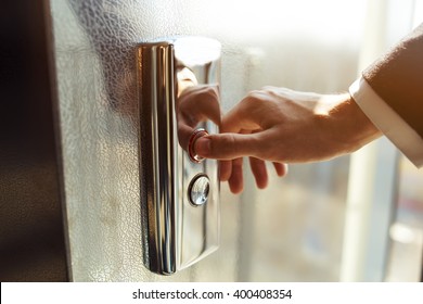 Man Pressing Elevator Button. Finger Presses The Elevator Button. Red Button. Sunset Light. Businessman Is A Lift. High Floor. Hand Reaches For The Button Of The Elevator Call.