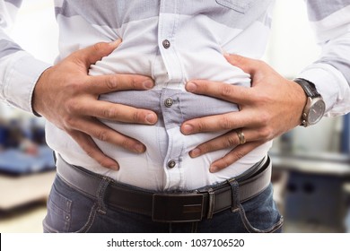 Man Pressing Grabbing Bloated Abdomen Or Belly As Cramp Flatulence Constipation Problem