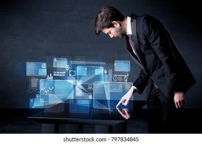 Man pressing technology smart table interface with blue graphs