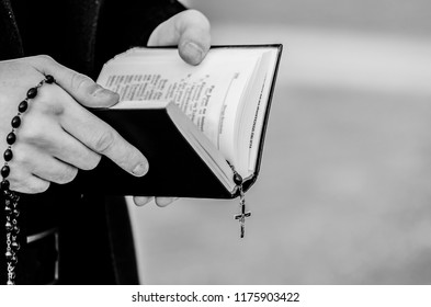 Man Priest With Book On Church Street
