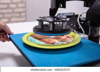 Man Printing On Plates  In Workshop