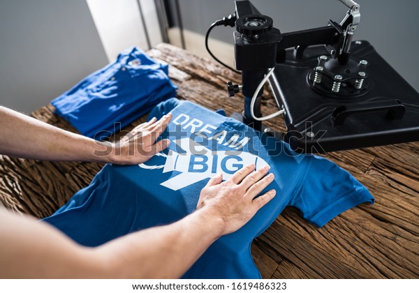 Man Printing On T Shirt\
In Workshop