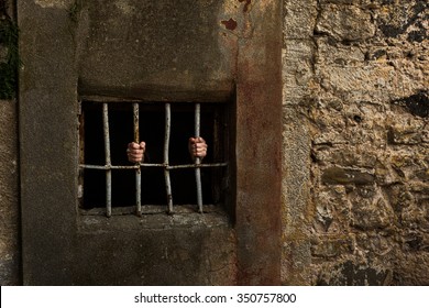 Man in prison and behind grate