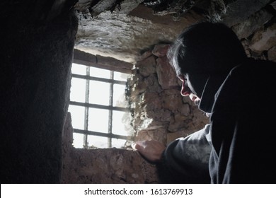 Man prisoner or captive in the dark underground cell