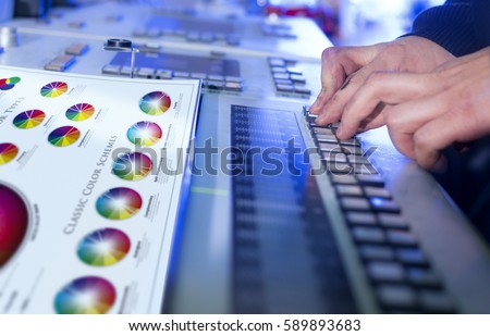 Man in the process of offset printing and color correction with changed original printed sheet.