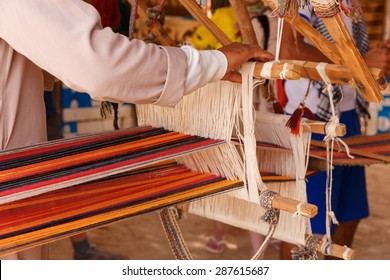 A man produces the fabric on a traditional loom in the Bedouin village, Egypt
