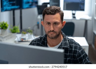 Man programmer and data engineer sketch diagrams and write code on tablet and computer in a hybrid workplace planning interfaces network solutions data flows and application logic during business hours.