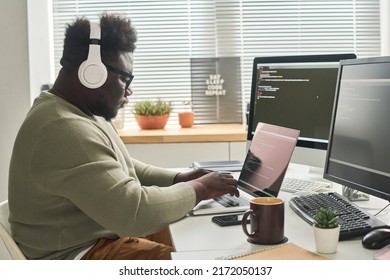 Man programming new apps on laptop