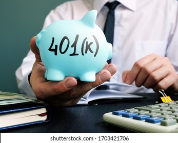 Man Proposes Piggy Bank With Sign 401k. Retirement Pension Plan.