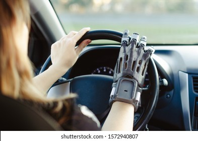 A Man With A Prosthetic Arm Printed On A 3D Printer Drives A Car.