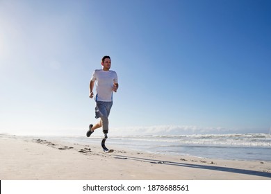 Man With prosthetic Leg Running Along the Beach - Powered by Shutterstock