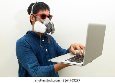 Man Protection Cartridge Respirator Gas Mask  Using Laptop.