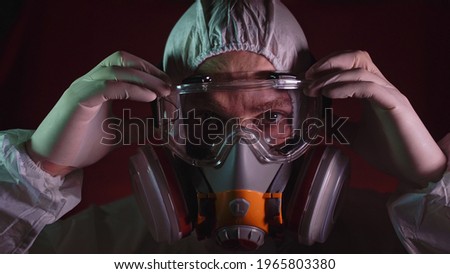 Man in protective costume suit, gas protect medical spray paint mask. Doctor in respirator. Concept health virus coronavirus epidemic. Stok fotoğraf © 