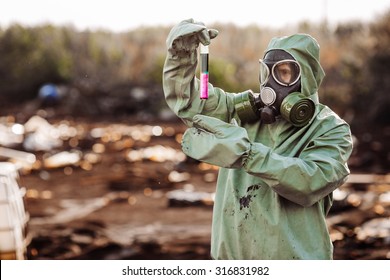Man with protective mask and protective clothes explores danger area
