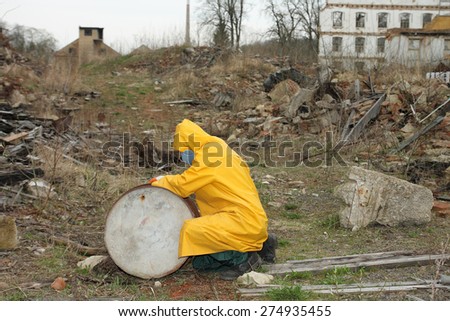 Man with protective  mask and protective  clothes  explores danger area.