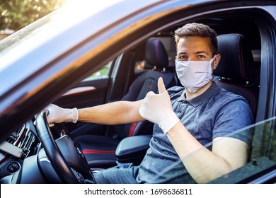 Man With Protective Mask And Gloves Driving A Car. Infection Prevention And Control Of Epidemic. World Pandemic. Stay Safe Showing Thumbs Up.