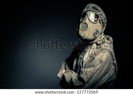 Man in protective suit against black background