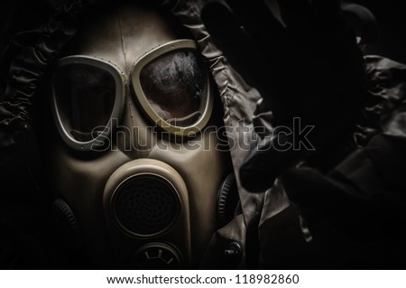 Man in protective suit against dark background