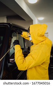 Man In Protective Suit And Mask Disinfection Car With Ozone Which Killing Viruses During Coronavirus Epidemic In Europe.