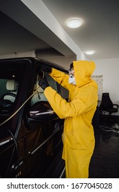 Man In Protective Suit And Mask Disinfection Car With Ozone Which Killing Viruses During Coronavirus Epidemic In Europe.