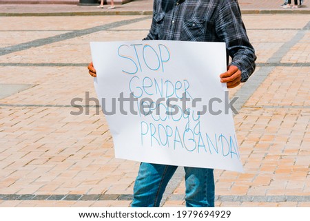 Man protesting with a paper banner 